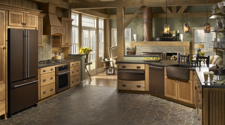 The richly hued Oiled Bronze collection of appliances cabinetry, countertop, cuisine classique, floor, flooring, hardwood, interior design, kitchen, laminate flooring, room, tile, wood flooring, brown