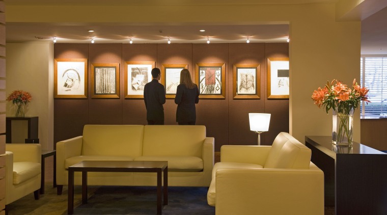 A view of the hotel lobby featuring parquet ceiling, furniture, interior design, living room, lobby, room, waiting room, brown
