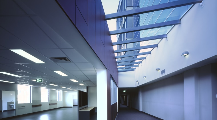 A skylight along the lenght of the building's architecture, ceiling, commercial building, corporate headquarters, daylighting, daytime, glass, headquarters, interior design, line, structure, teal, blue