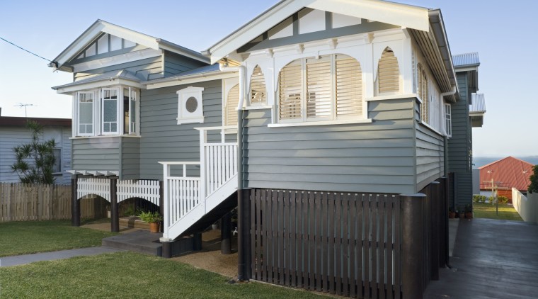 An exterior view of the entrance way to building, cottage, elevation, facade, home, house, property, real estate, residential area, siding