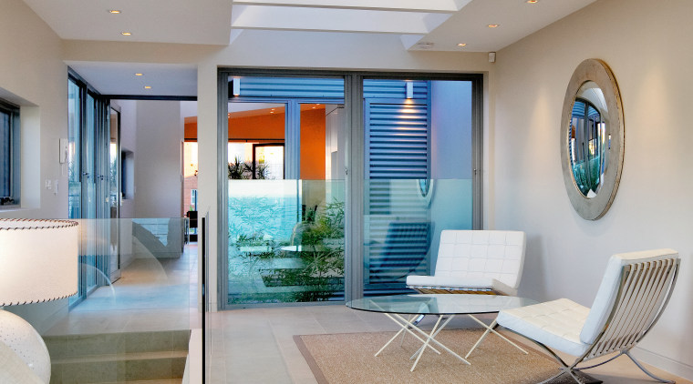 Frameless glass panels allow clear sight lines through ceiling, home, interior design, living room, real estate, gray