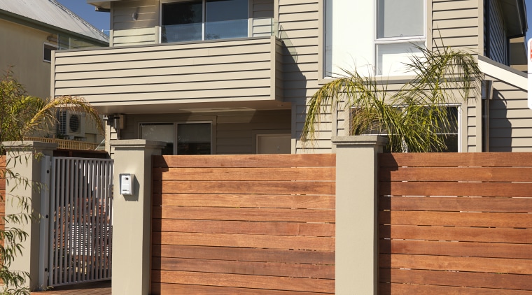 An exterior view of this house featuring Jame building, elevation, facade, fence, gate, home, home fencing, house, neighbourhood, property, real estate, residential area, siding, suburb, orange