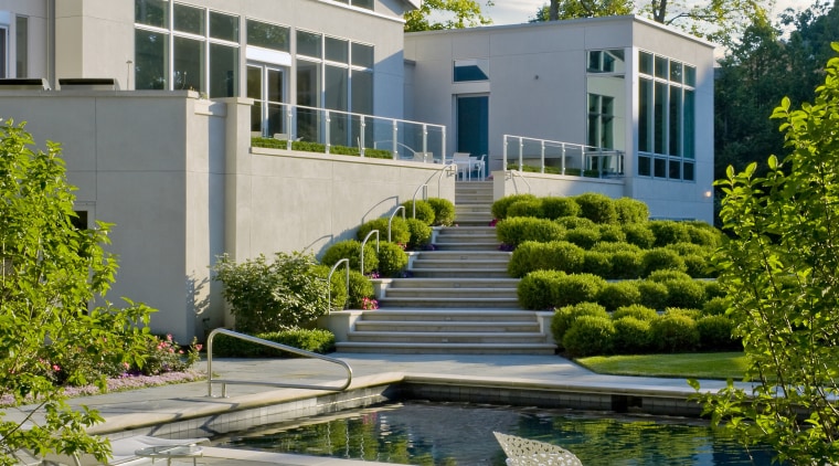 View of the house, white plaster walls, pool, architecture, condominium, corporate headquarters, daytime, estate, facade, headquarters, home, house, landscaping, mixed use, real estate, reflecting pool, reflection, residential area, tree, urban design, water, gray