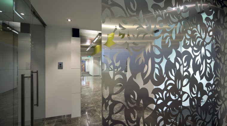 A glass screen with a delicate leaf pattern ceiling, glass, interior design, lobby, mural, wall, gray, black