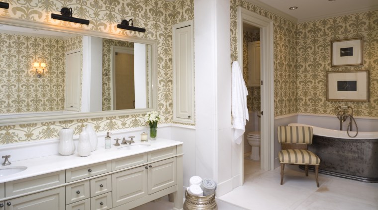 view of bathroom featuring bath tub, bathroom cabinetry, bathroom, bathroom accessory, ceiling, floor, flooring, home, interior design, room, tile, wall, window, gray, brown