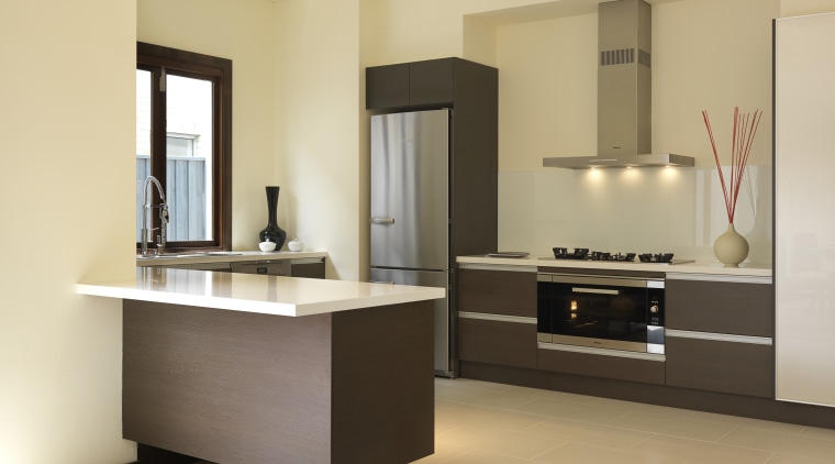 Rather than specifying standard 60cm cooking appliances, the cabinetry, countertop, floor, furniture, interior design, kitchen, product design, room, sink, orange, brown