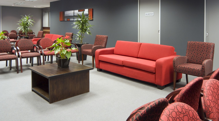 Vibrant red and gray furnishings enliven the couch, furniture, interior design, living room, loveseat, room, table, waiting room, red, gray