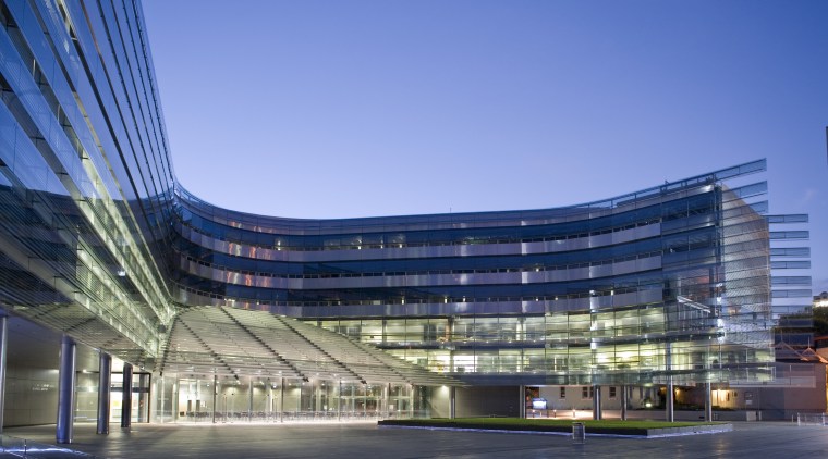 View of the exterior of the Owen G architecture, building, city, commercial building, condominium, convention center, corporate headquarters, daytime, headquarters, landmark, metropolis, metropolitan area, mixed use, reflection, sky, structure, blue