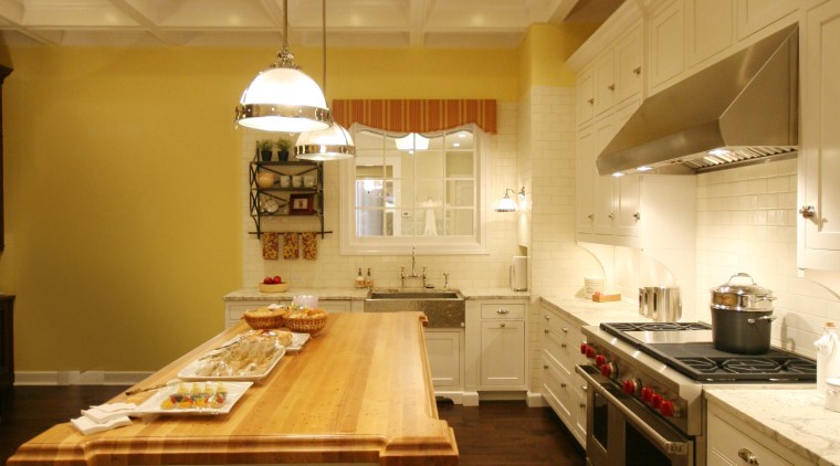 View of the Kitchen with a wooden island cabinetry, ceiling, countertop, cuisine classique, floor, flooring, hardwood, home, interior design, kitchen, lighting, room, under cabinet lighting, wood, wood flooring, brown, orange