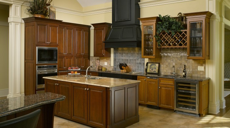 A simple door style and stacked appliances complement cabinetry, countertop, cuisine classique, hardwood, interior design, kitchen, room, brown, orange