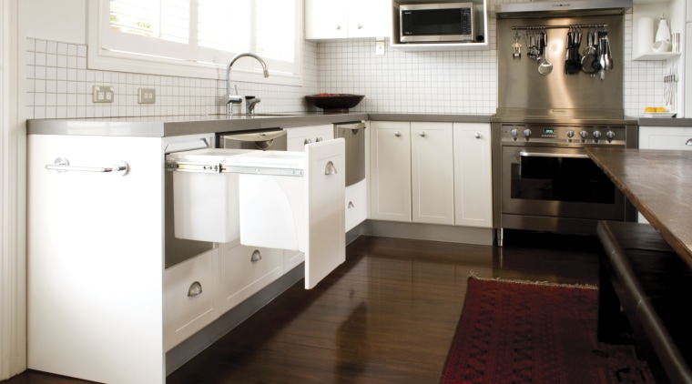 Hideaway Bins from Kitchen King roll out of cabinetry, countertop, cuisine classique, floor, flooring, hardwood, home appliance, interior design, kitchen, kitchen stove, laminate flooring, room, tile, wood flooring, white