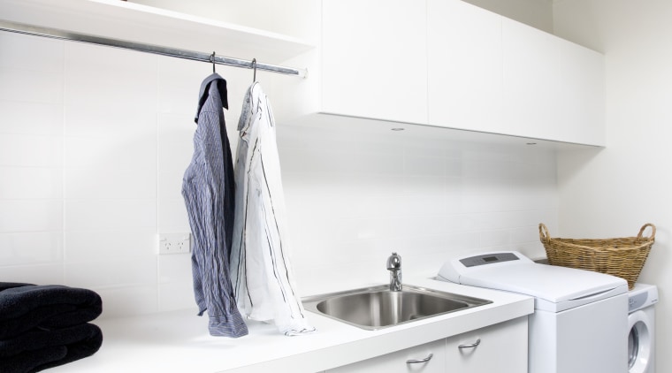 View of a laundry which was added to countertop, floor, furniture, interior design, kitchen, laundry room, product design, room, white, gray