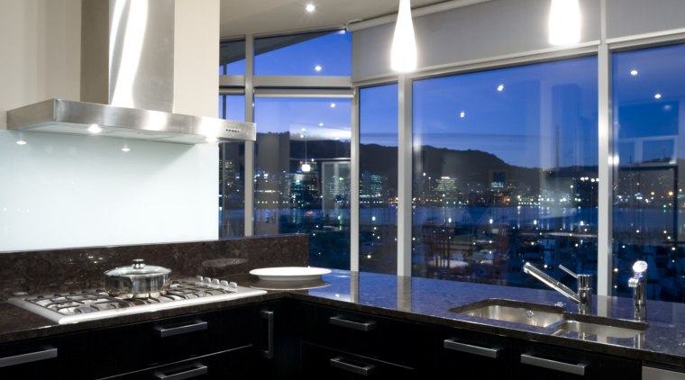 Deep-toned, reflective surfaces give this kitchen an atmospheric architecture, ceiling, countertop, daylighting, interior design, kitchen, lighting, room, gray, black