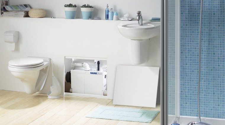 View of a bathroom which features a macerating bathroom, bathroom accessory, bathroom cabinet, bathroom sink, ceramic, floor, interior design, plumbing fixture, product, product design, room, tap, tile, toilet seat, wall, white