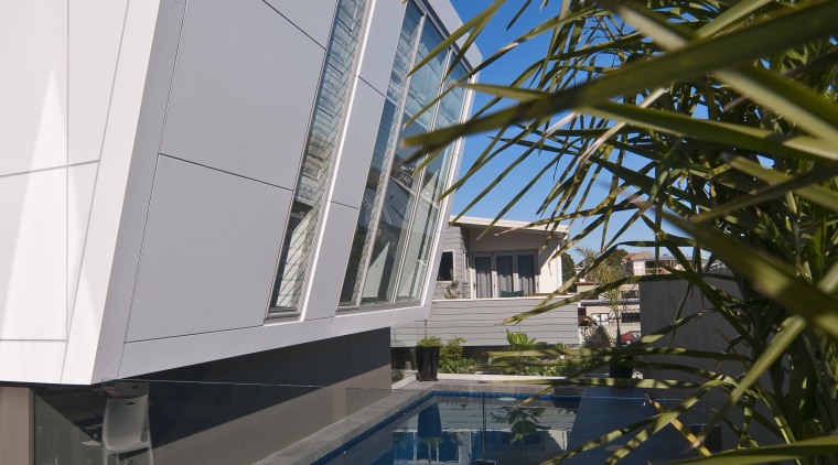 Image of a residential minimalist pool constructed by architecture, building, daylighting, daytime, facade, house, reflection, sky, swimming pool, water, black