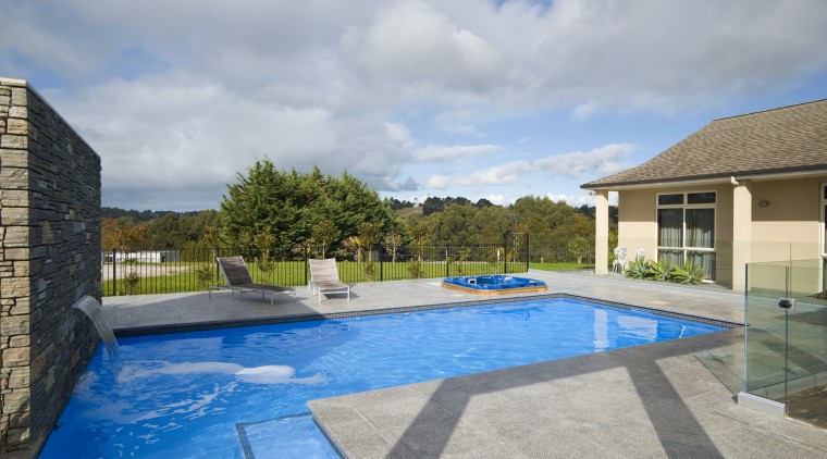 This new L-shaped pool, designed and built by estate, home, house, leisure, property, real estate, sky, swimming pool, villa, water, gray