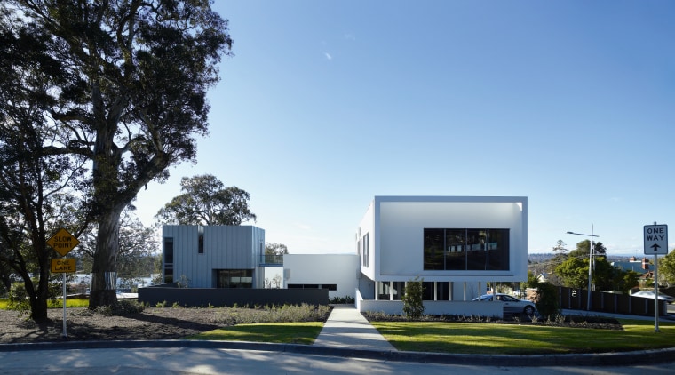View of the exterior of the town houses architecture, building, corporate headquarters, facade, home, house, property, real estate, residential area, sky, teal, black