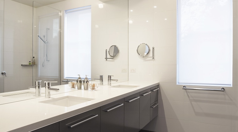 Bathrooms are designed in cool neutrals, with dark architecture, bathroom, ceiling, countertop, daylighting, floor, home, interior design, real estate, room, sink, tile, white