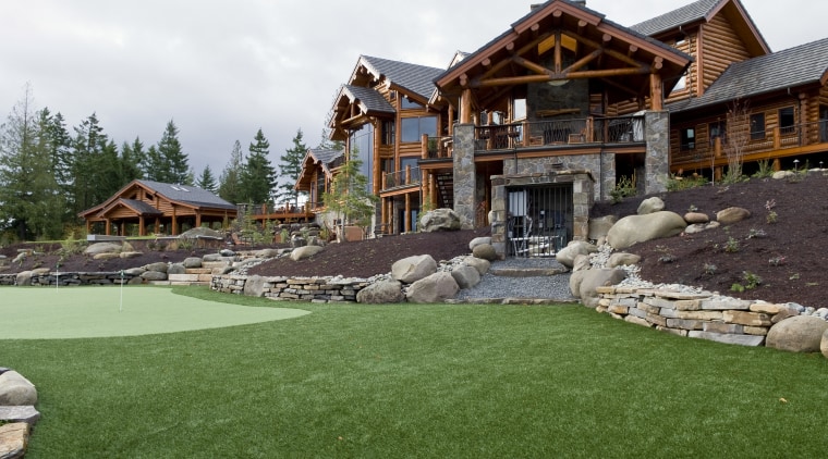 Exterior view of this home which has been backyard, estate, grass, home, landscape, landscaping, lawn, plant, yard, green