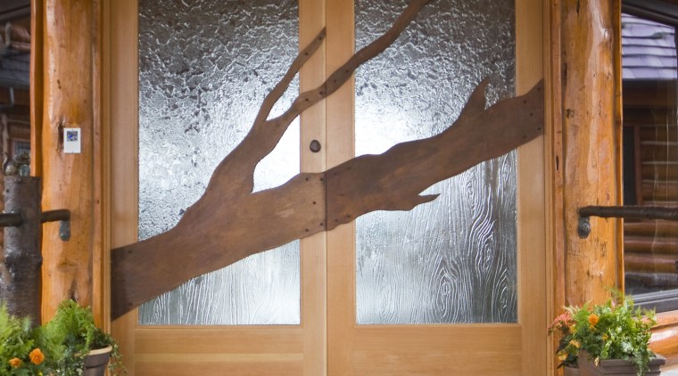 Image of unique designs on glass doors created door, floor, flooring, hardwood, home, house, interior design, outdoor structure, porch, real estate, wall, window, wood, wood stain, brown