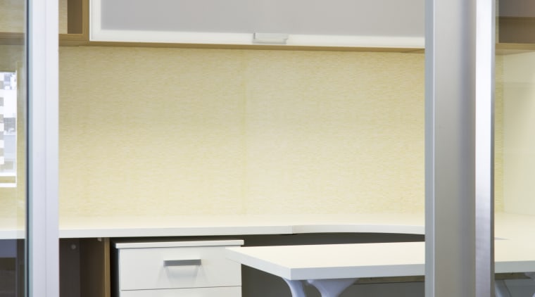 Interior view of an office which includes office chest of drawers, desk, furniture, interior design, office, product design, shelf, shelving, table, wall, gray