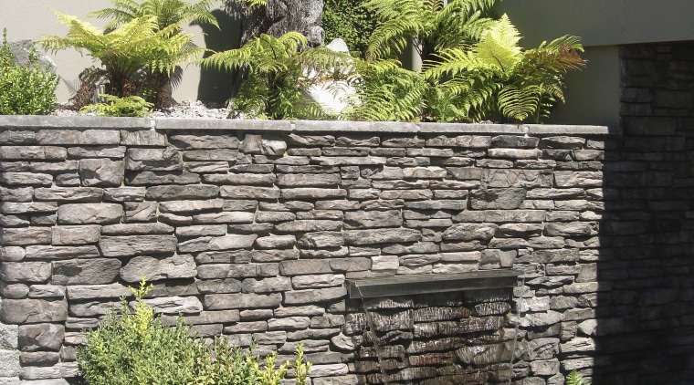 View of garden which includes a stone wall courtyard, garden, landscape, landscaping, plant, stone wall, walkway, wall, yard, black, white