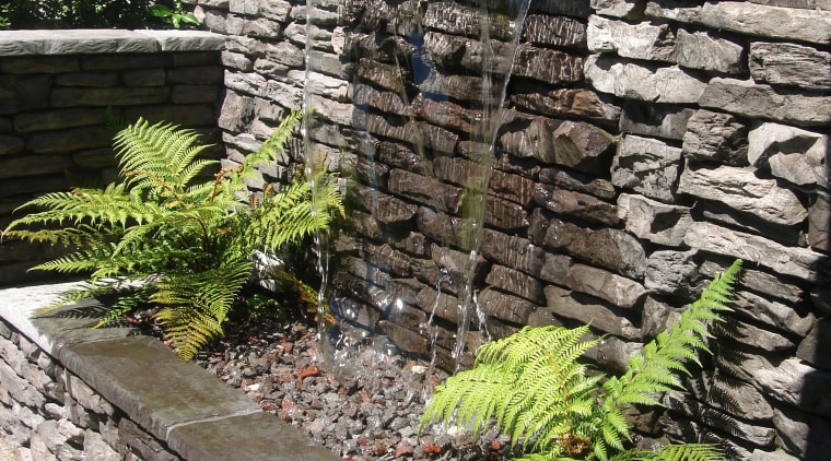 View of garden which includes a stone wall garden, grass, landscape, landscaping, outdoor structure, plant, stone wall, walkway, wall, gray, black