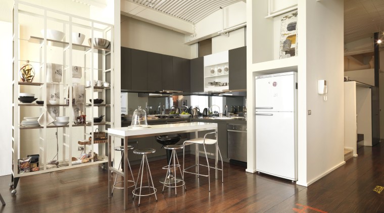 View of kitchen area with dark-stained timber flooring, floor, flooring, interior design, kitchen, loft, wood flooring, white, brown