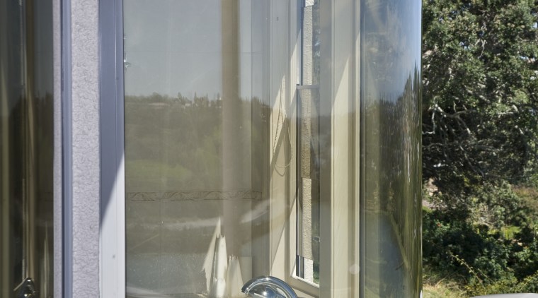 View of a curved bathroom window which was glass, window, gray
