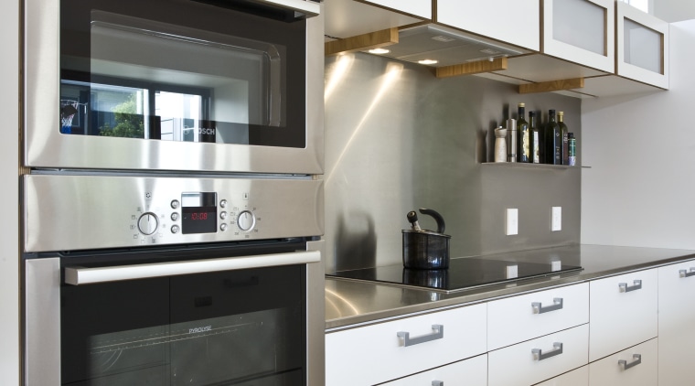 View of kitchen which features white cabinetry with cabinetry, countertop, cuisine classique, home appliance, interior design, kitchen, kitchen appliance, gray, white