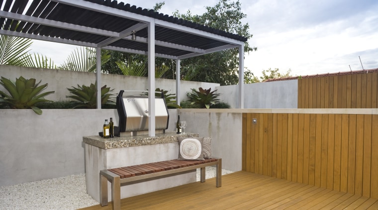 View of outdoor entertaining area which features a backyard, house, outdoor structure, property, real estate, roof, gray