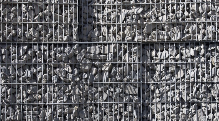 View of a large retaining wall with a black and white, brick, monochrome, monochrome photography, pattern, stone wall, structure, texture, wall, black