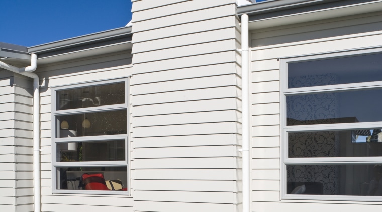 Exterior view of Harmony Homes show home which architecture, building, elevation, facade, home, house, property, real estate, residential area, siding, sky, window, white, blue