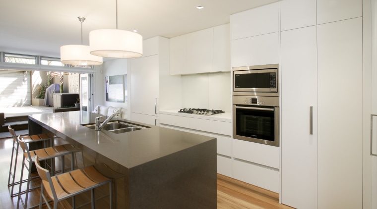 View of a narrow kitchen designed by Wonderful cabinetry, countertop, cuisine classique, floor, interior design, kitchen, real estate, wood flooring, white