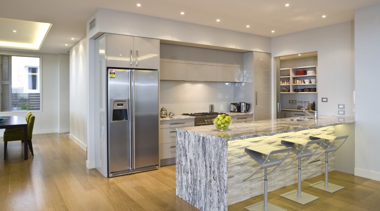 View of the kitchen at the Harbourcity developed cabinetry, countertop, floor, flooring, hardwood, interior design, kitchen, laminate flooring, real estate, room, wood flooring, gray