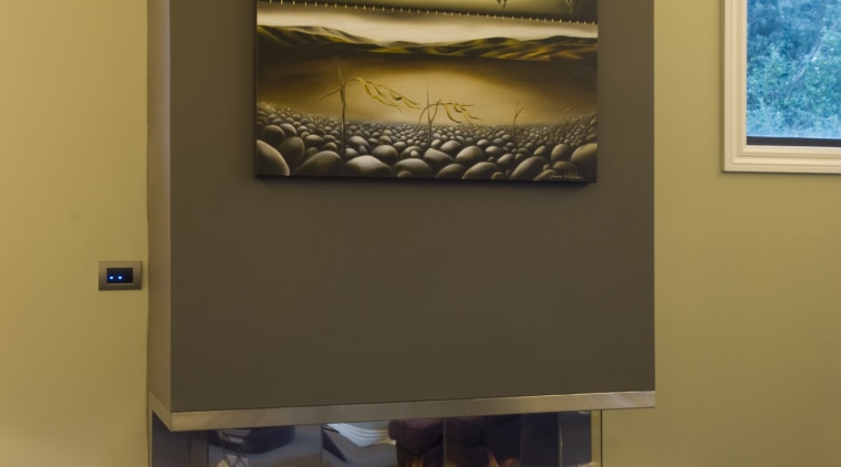 View of living area which features the Eastside fireplace, hearth, brown