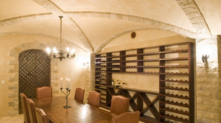 View of a wine cellar which features limestone architecture, ceiling, estate, floor, flooring, interior design, room, wall, wine cellar, orange, brown