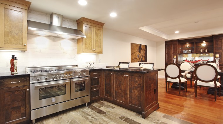View of a contemporary kitchen which features a cabinetry, countertop, cuisine classique, estate, floor, flooring, hardwood, interior design, kitchen, property, real estate, room, wood flooring, orange, white