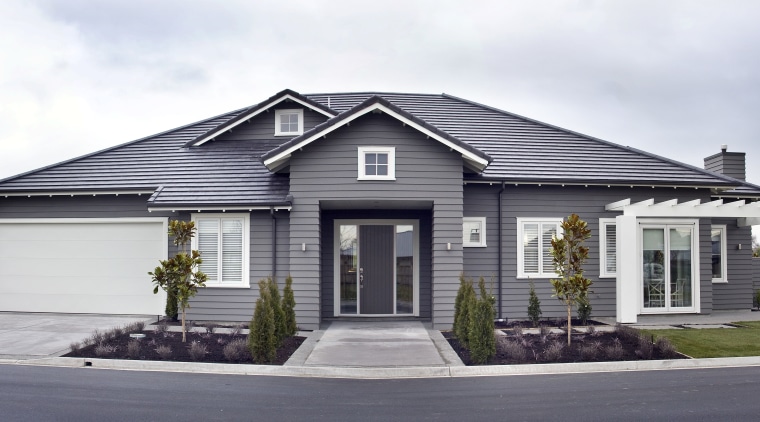 Exterior view of a Landmark Homes show home building, cottage, elevation, estate, facade, home, house, neighbourhood, property, real estate, residential area, siding, suburb, white, gray