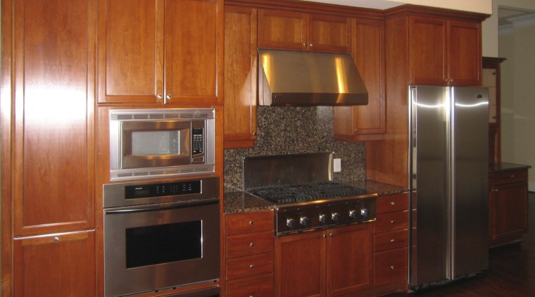 View of the condominiums kitchen before renovation cabinetry, countertop, cuisine classique, floor, flooring, furniture, hardwood, home appliance, interior design, kitchen, room, under cabinet lighting, red