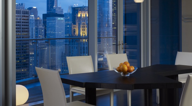 View of the Chicago skyline from the condominium. apartment, architecture, chair, dining room, furniture, interior design, table, window, black, blue