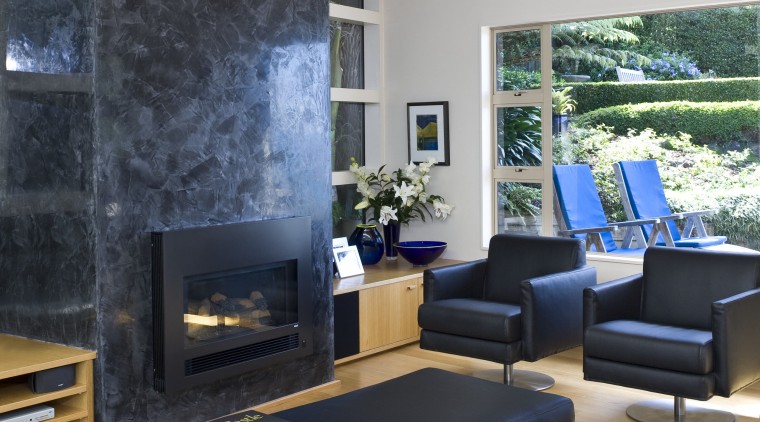 This is a lounge with the fire place couch, furniture, home, interior design, living room, room, table, wall, gray, black