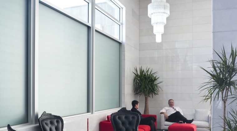 The office interiors at the Club Tower reflect architecture, ceiling, floor, furniture, home, house, interior design, living room, window, white, gray