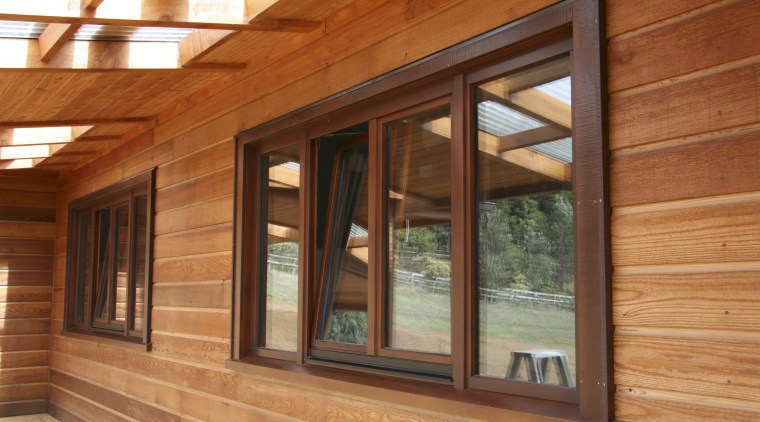 View of windows set into timber joinery by beam, door, facade, home, house, log cabin, lumber, real estate, siding, wall, window, wood, wood stain, brown, orange