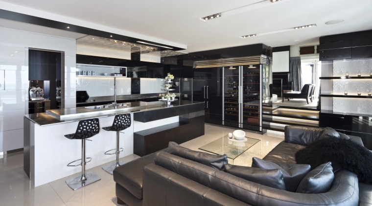 View of this living area situated by the interior design, kitchen, gray, black, white
