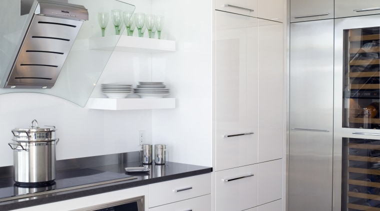 View of contemporary apartment kitchen which features timber cabinetry, countertop, cuisine classique, floor, home appliance, interior design, kitchen, kitchen appliance, kitchen stove, major appliance, refrigerator, room, gray, white