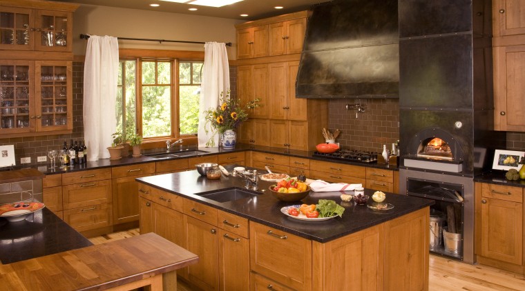 View of a Northwestern-styled kitchen with extensive wood cabinetry, countertop, cuisine classique, hardwood, interior design, kitchen, room, brown