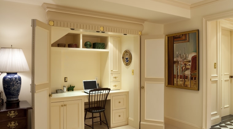 View of desk area under a staircase. - bedroom, ceiling, floor, flooring, home, interior design, lighting, living room, room, suite, wall, wood, wood flooring, orange, brown