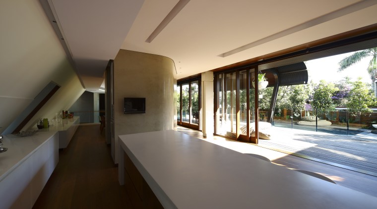 View of kitchen area featuring hardwood flooring, island architecture, daylighting, estate, home, house, interior design, property, real estate, window, black