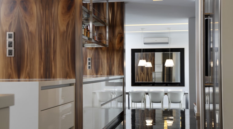 View of a bar style kitchen which features cabinetry, countertop, interior design, kitchen, gray, brown